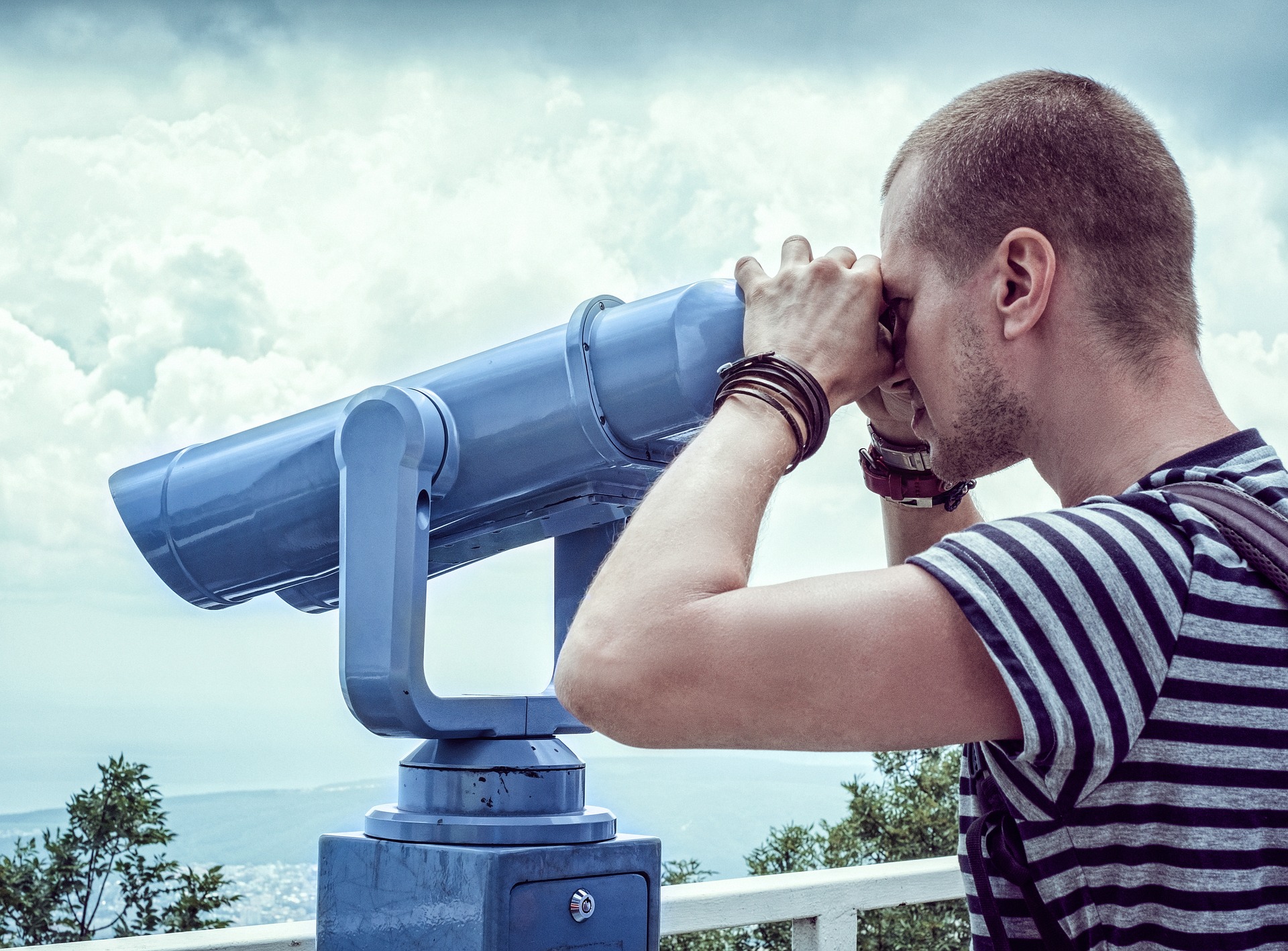 A person looking through binoculars to spot opportunities for innovation